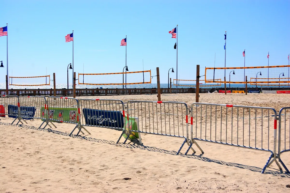This energetic beachside image captures volleyball nets set up on the sand, bordered by American flags and the ocean in the background. The area buzzes with potential for tournaments, social events, and active fun, representing Myrtle Beach’s lively outdoor scene.